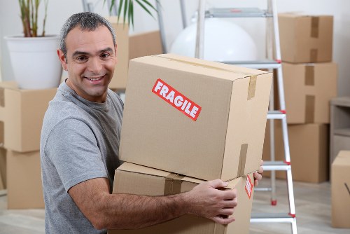 Local flat removals team handling boxes in Walthamstow