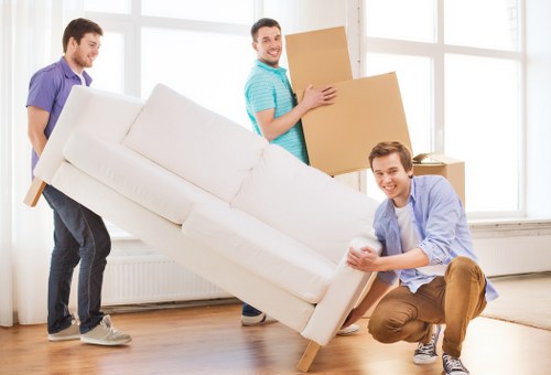 Business relocation team coordinating an office move with IT and furniture setup