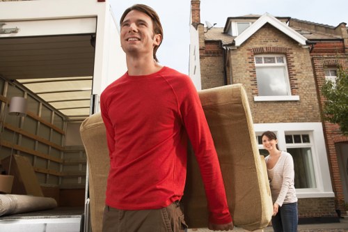 Trained moving staff handling boxes with care during a house move