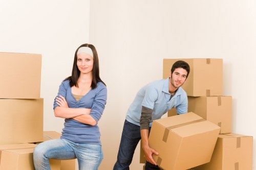 Professional movers carrying furniture from a local home