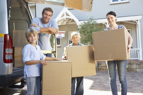 Local movers arranging large furniture for delivery in E17